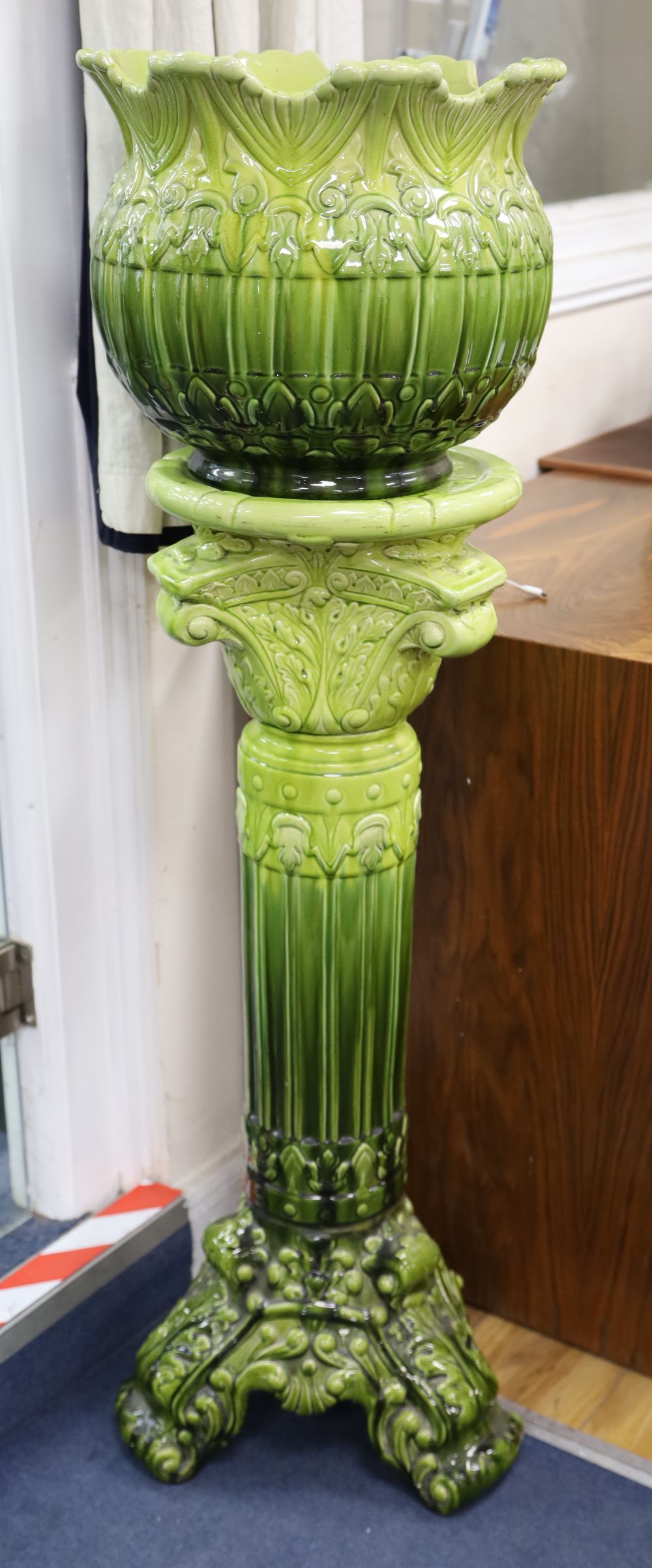An apple green-glazed majolica jardiniere on matching stand with acanthus and other foliate moulding